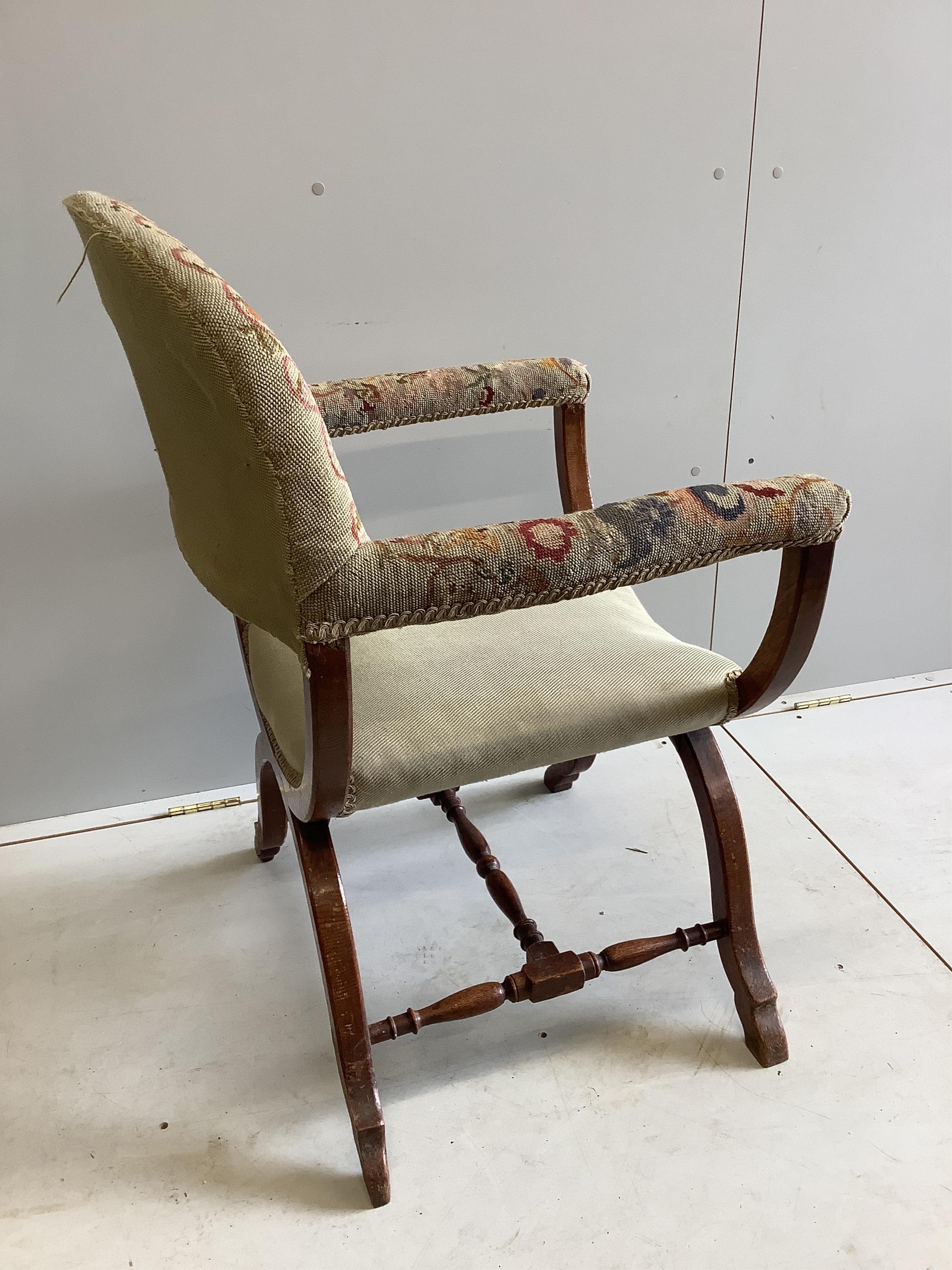 An early 20th century upholstered oak Savonarola style armchair, width 64cm, depth 53cm, height 96cm. Condition - fair